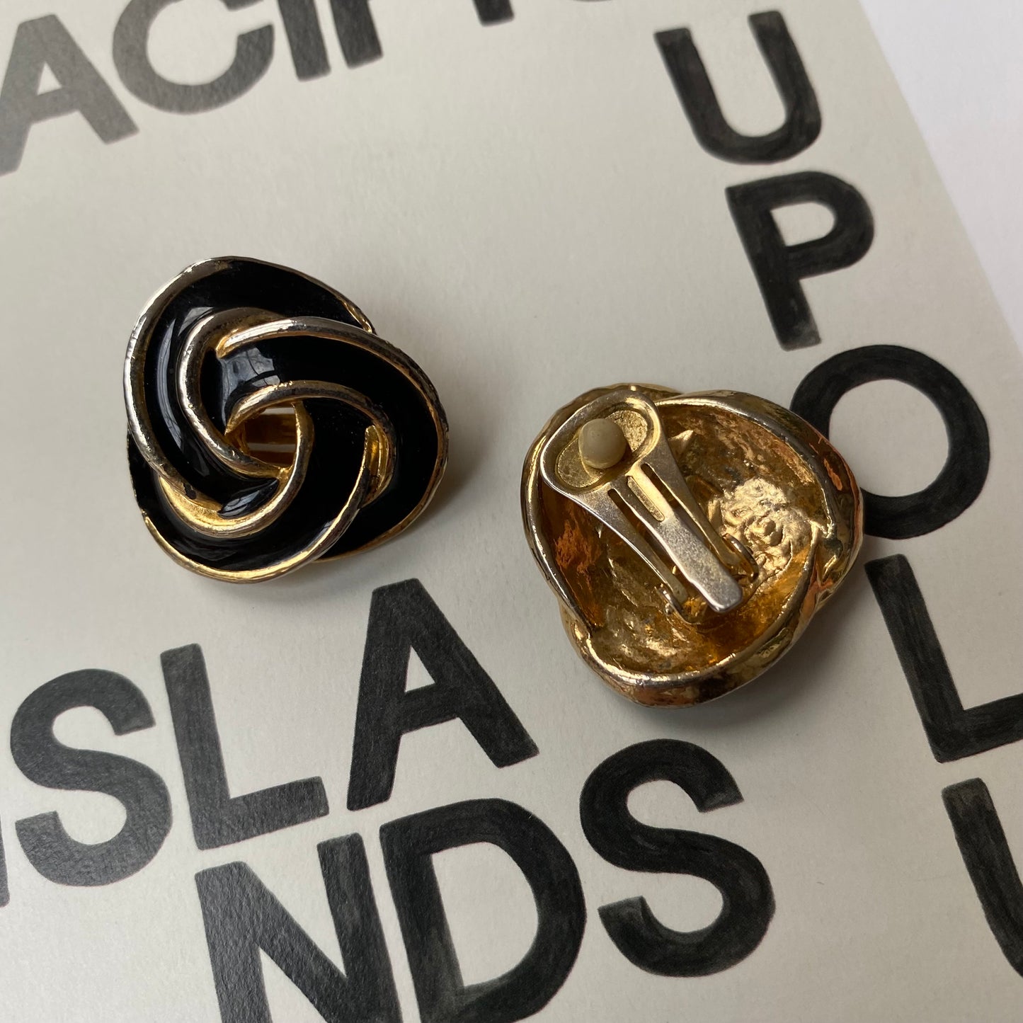 Vintage black and gold tone swirl clip on earrings