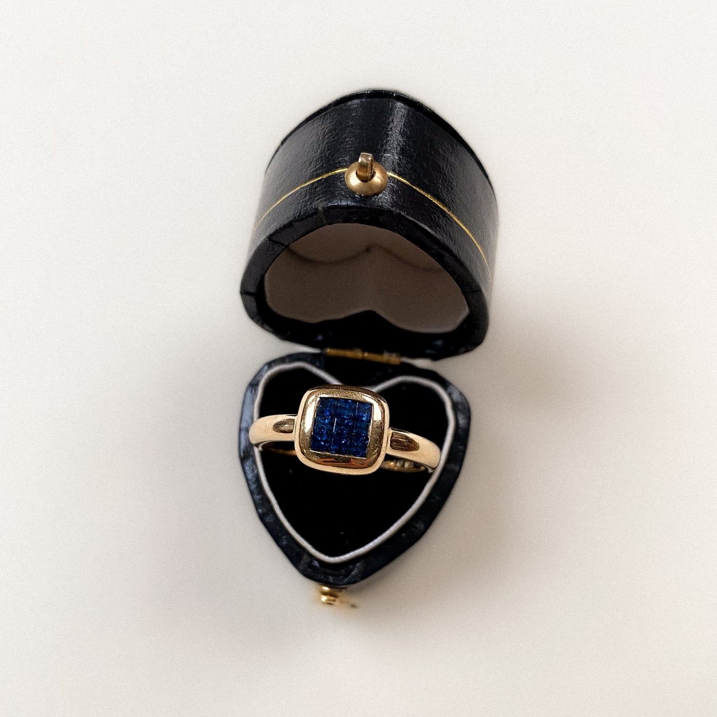 18 carat modern ring with square cut sapphire cluster