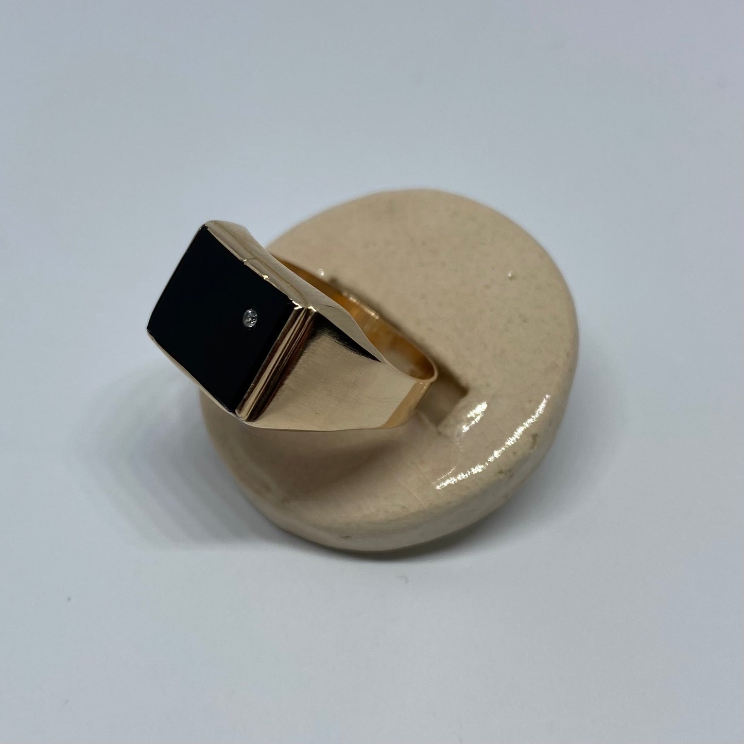 14 carat gold square onyx signet ring with small topaz
