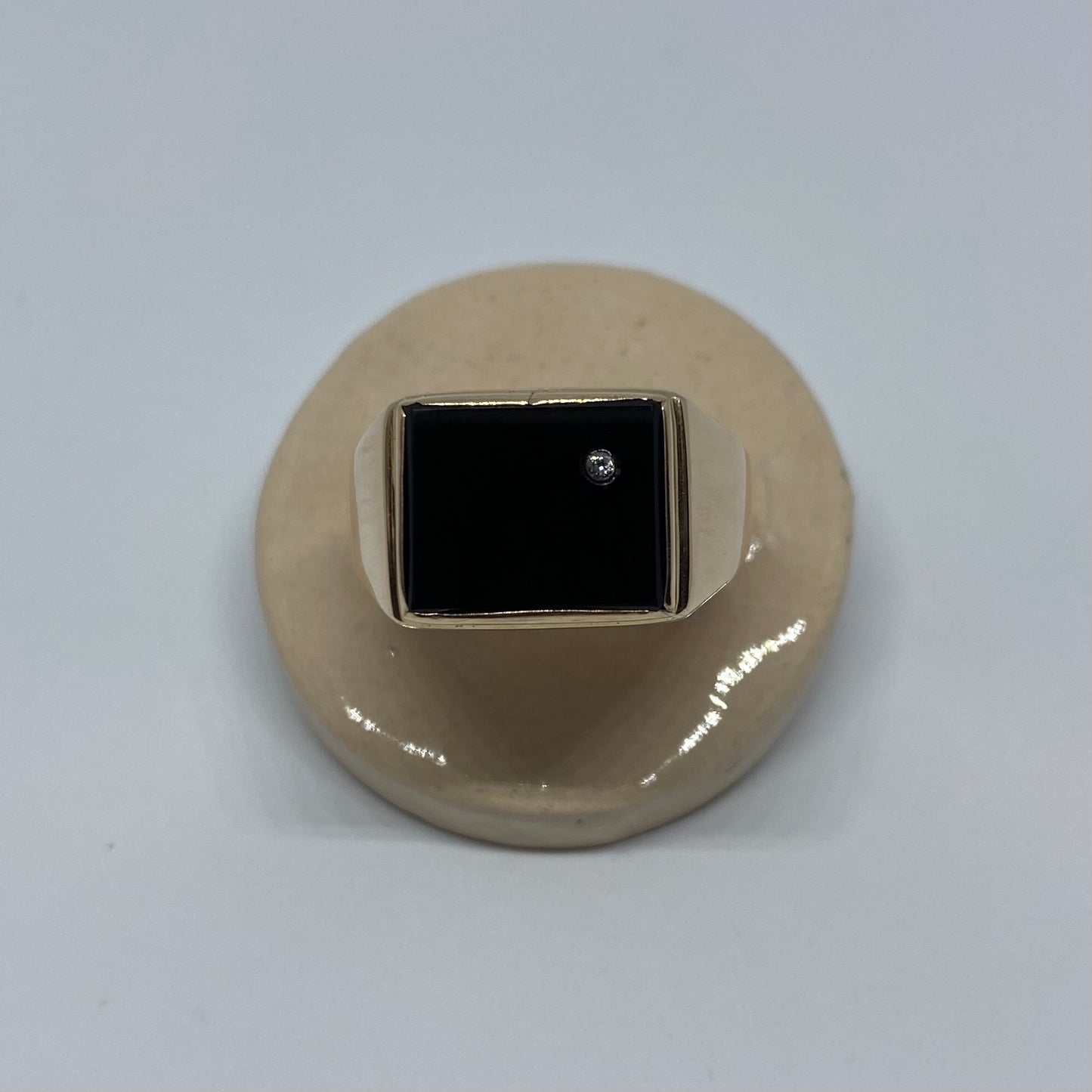 14 carat gold square onyx signet ring with small topaz