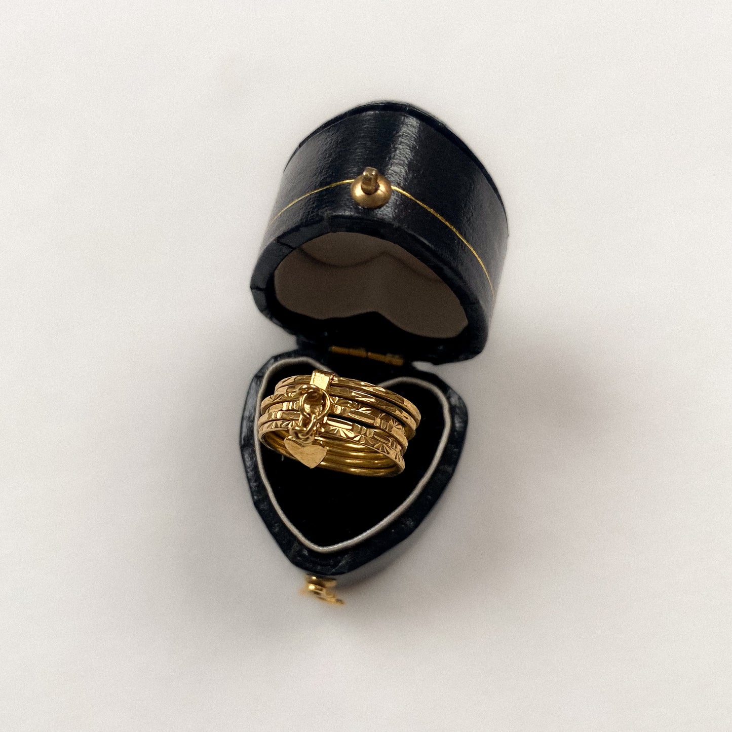 18 carat gold 6 engraved stack ring with heart pendant