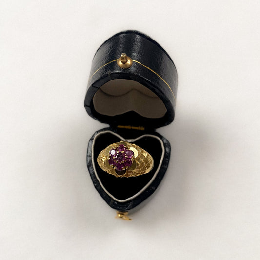 18 carat gold ruby daisy ring with decorative sides