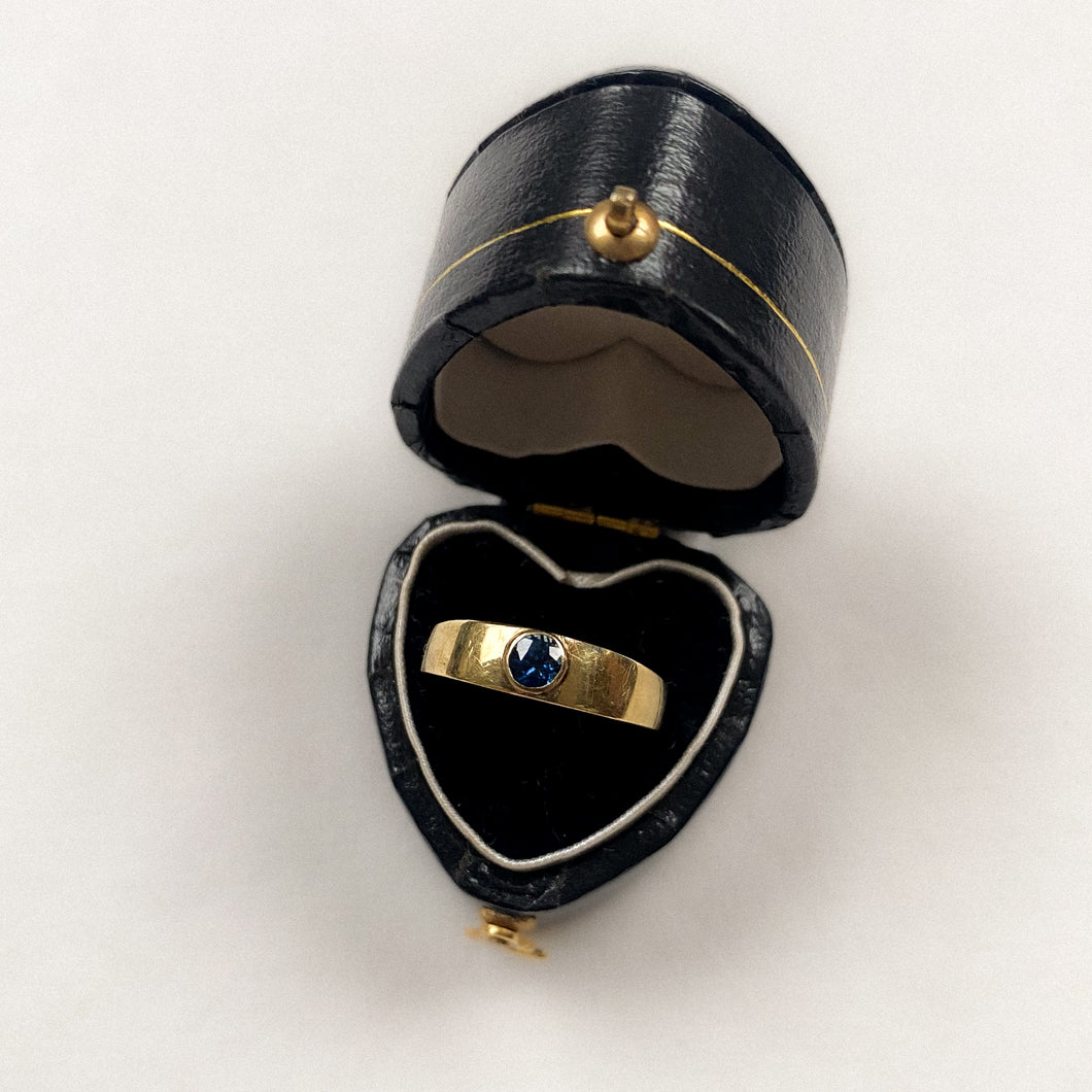 14 carat gold modern band ring with solitaire sapphire