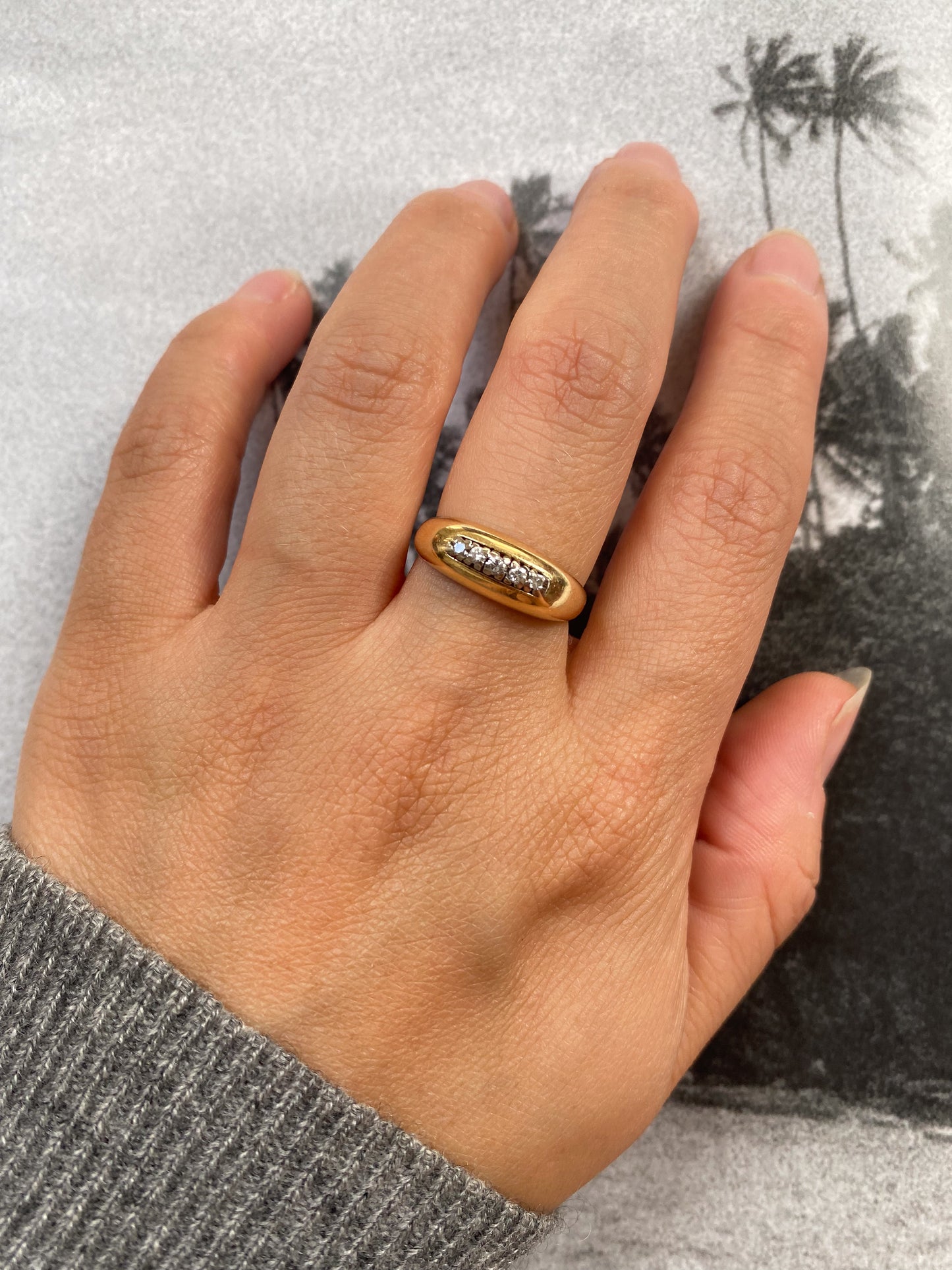 18 carat gold modern dome ring with row of diamonds