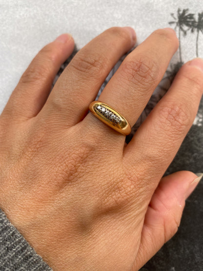 18 carat gold modern dome ring with row of diamonds