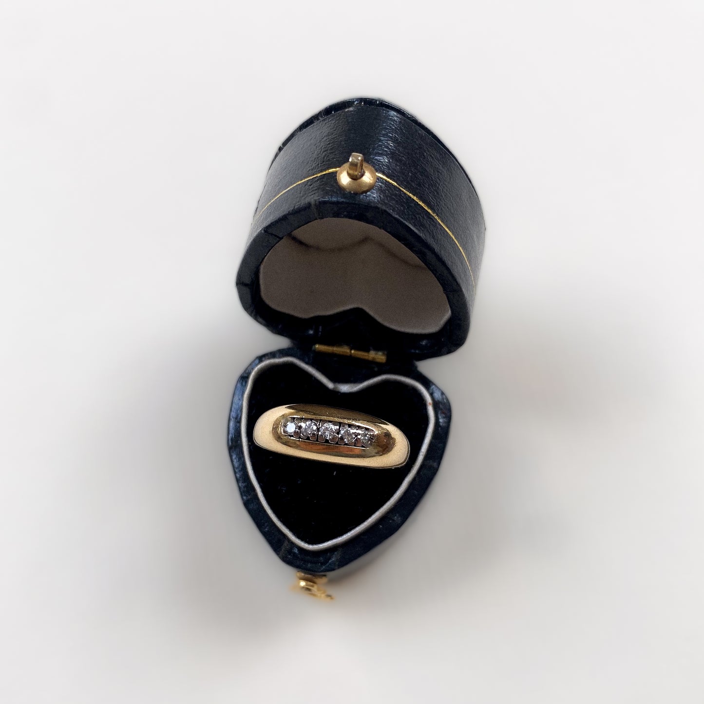 18 carat gold modern dome ring with row of diamonds