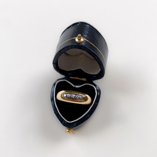 18 carat gold modern dome ring with row of diamonds