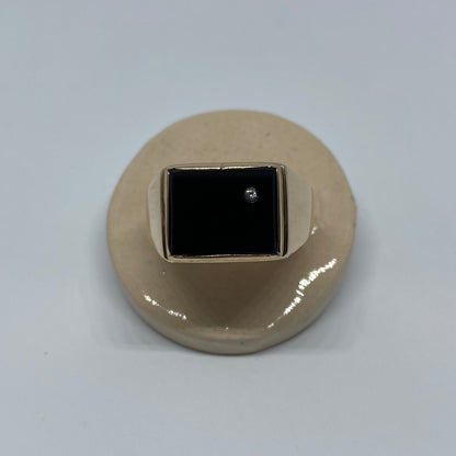 14 carat gold square onyx signet ring with small topaz